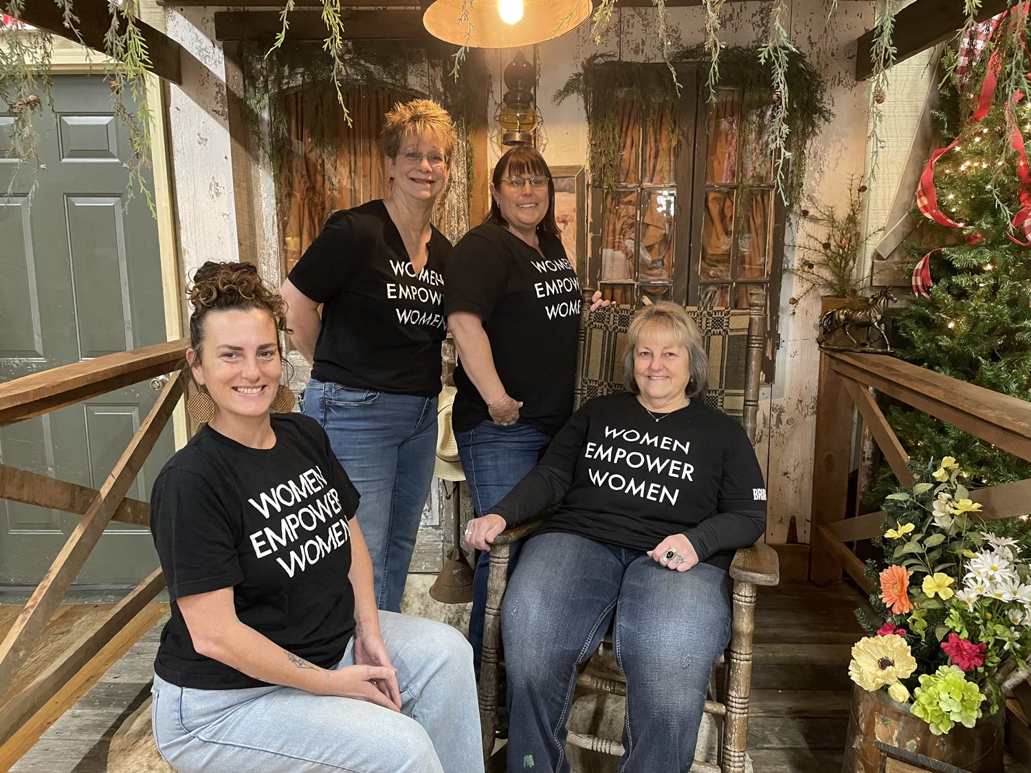 Danell Fogle and The Briar Rose team wearing Women Empower Women shirts inside the shop